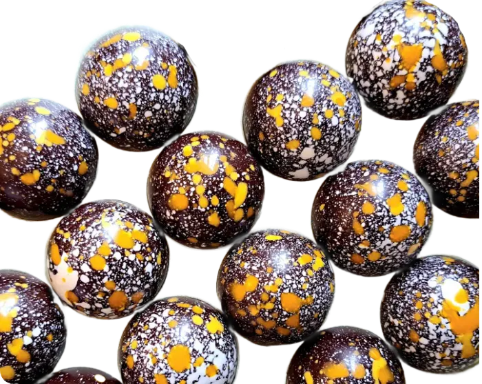 An image of delicous round chocolates with gold flakes
